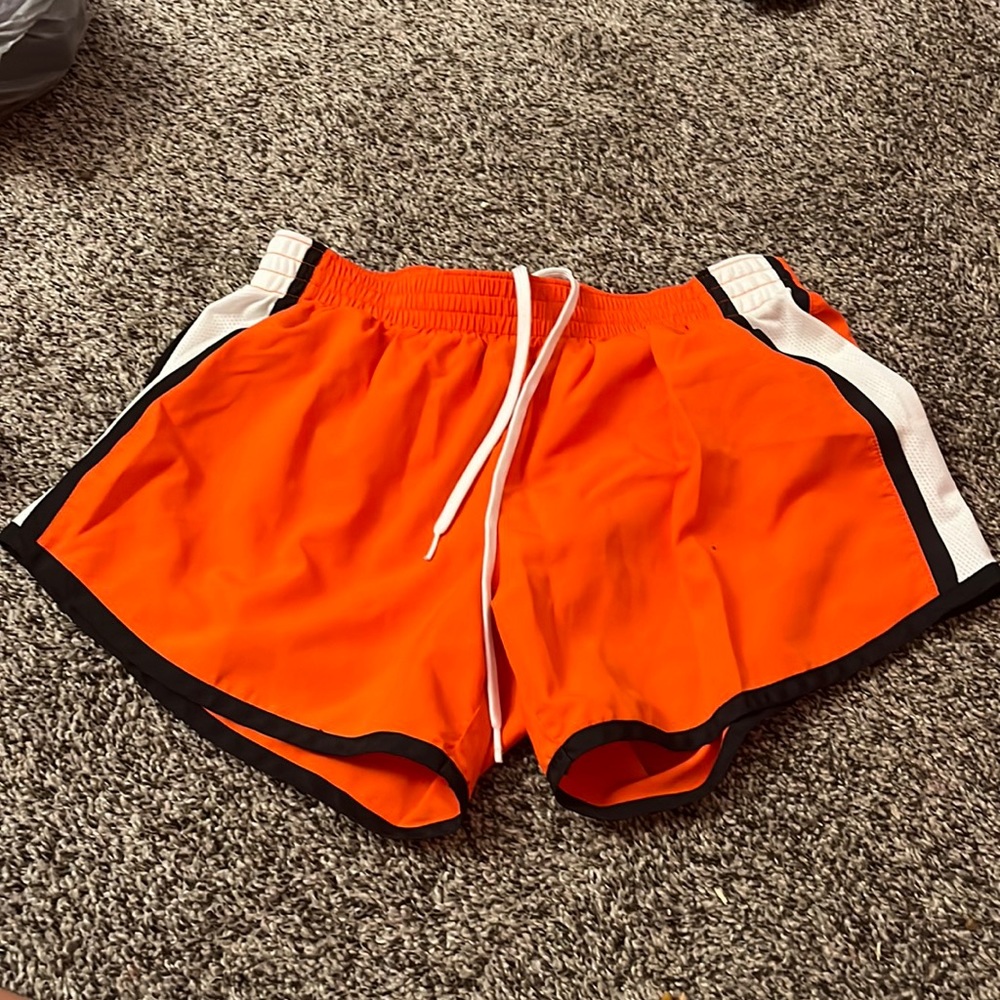 Orange and black and white athletic shorts